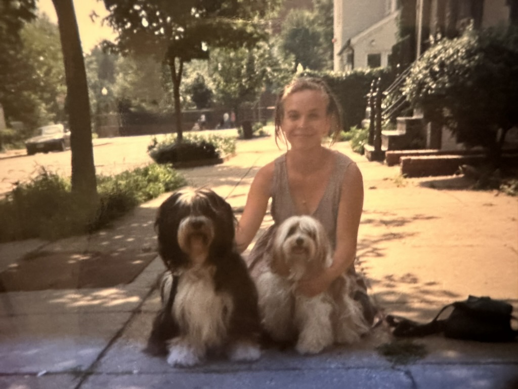 Deidre holding a dog at a formal event